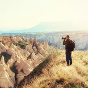 photographer sandstone cliff and observing